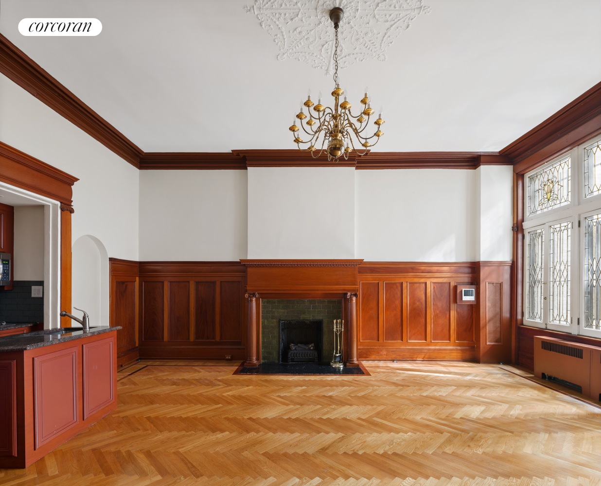 a view of an empty room with a fireplace and a window