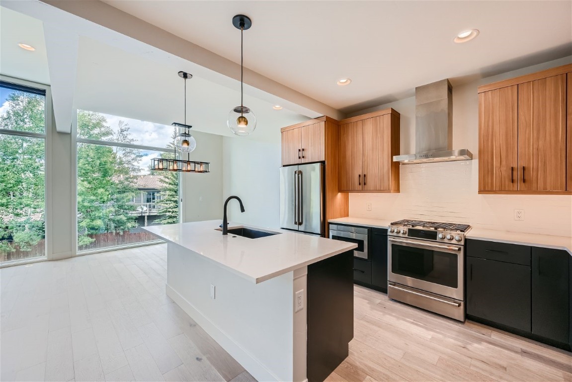 a kitchen with stainless steel appliances granite countertop a sink stove and refrigerator