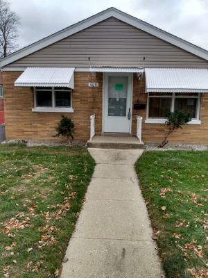 a front view of a house with a yard and porch