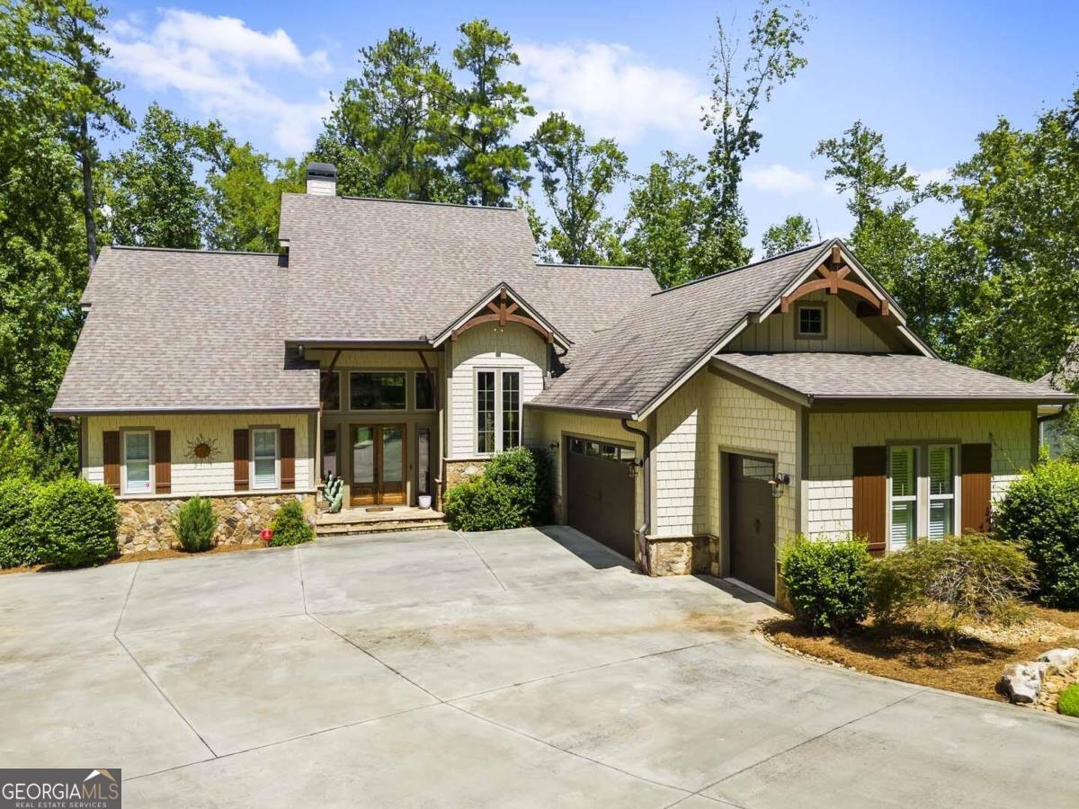 a front view of a house with a garden