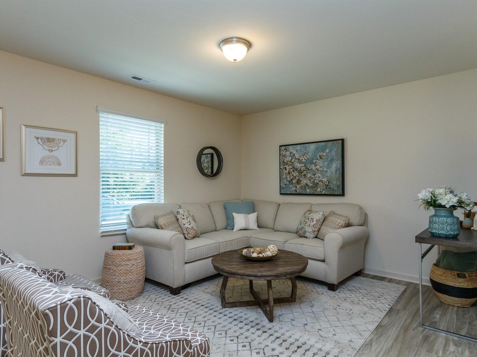 a living room with furniture and a window