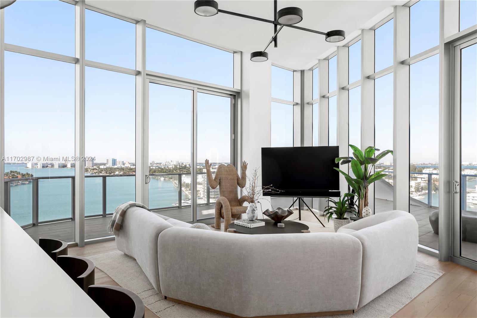 a living room with couches a coffee table and a flat screen tv