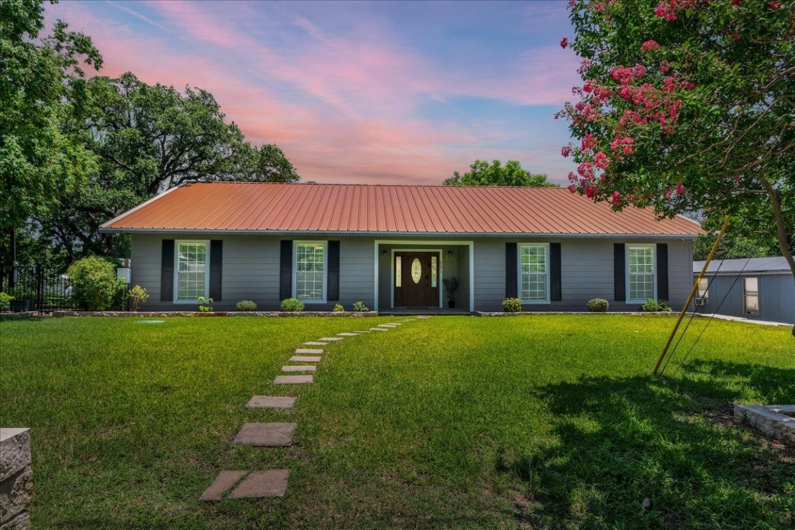 a front view of a house with a garden