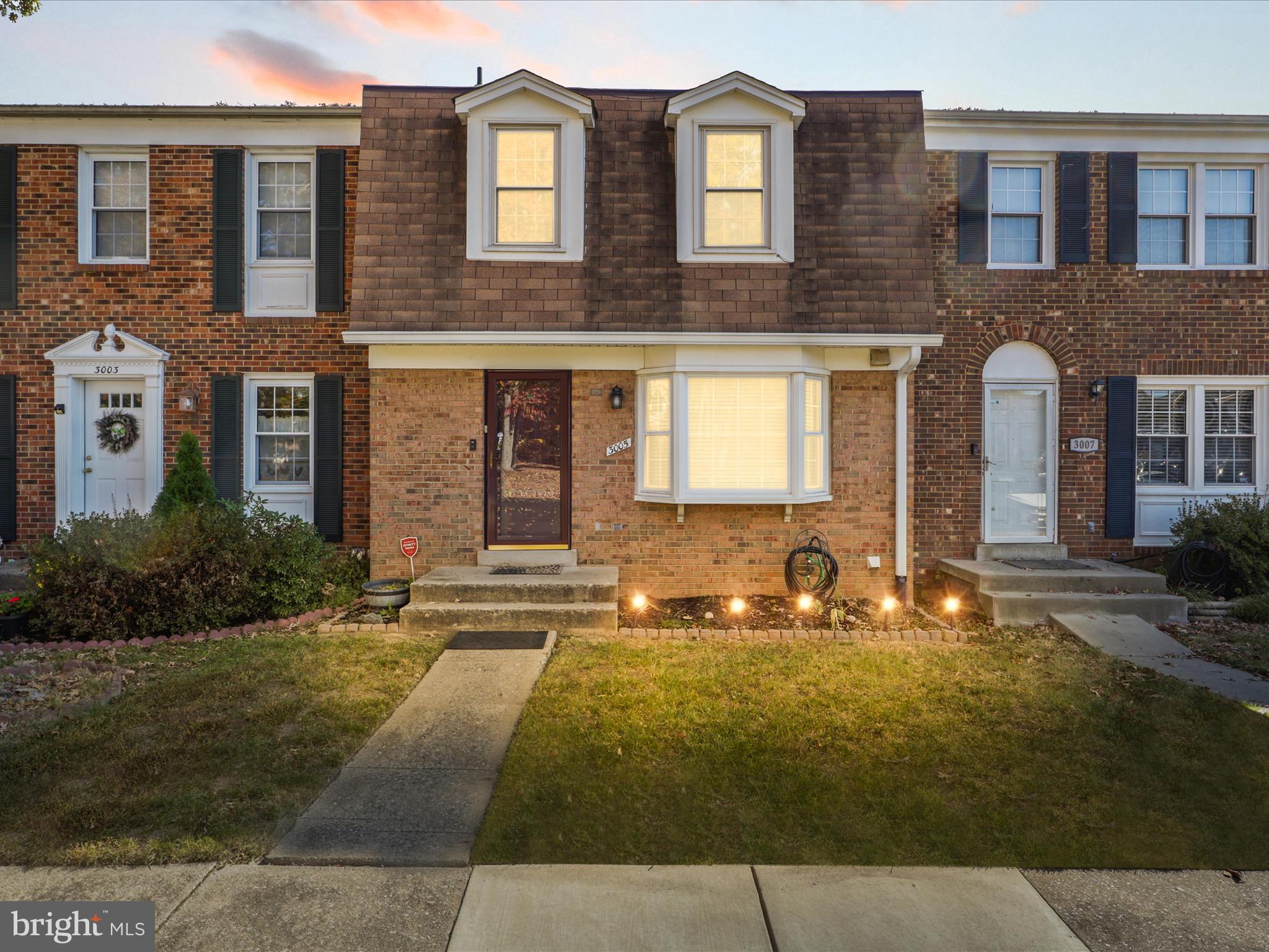 a front view of brick house with yard