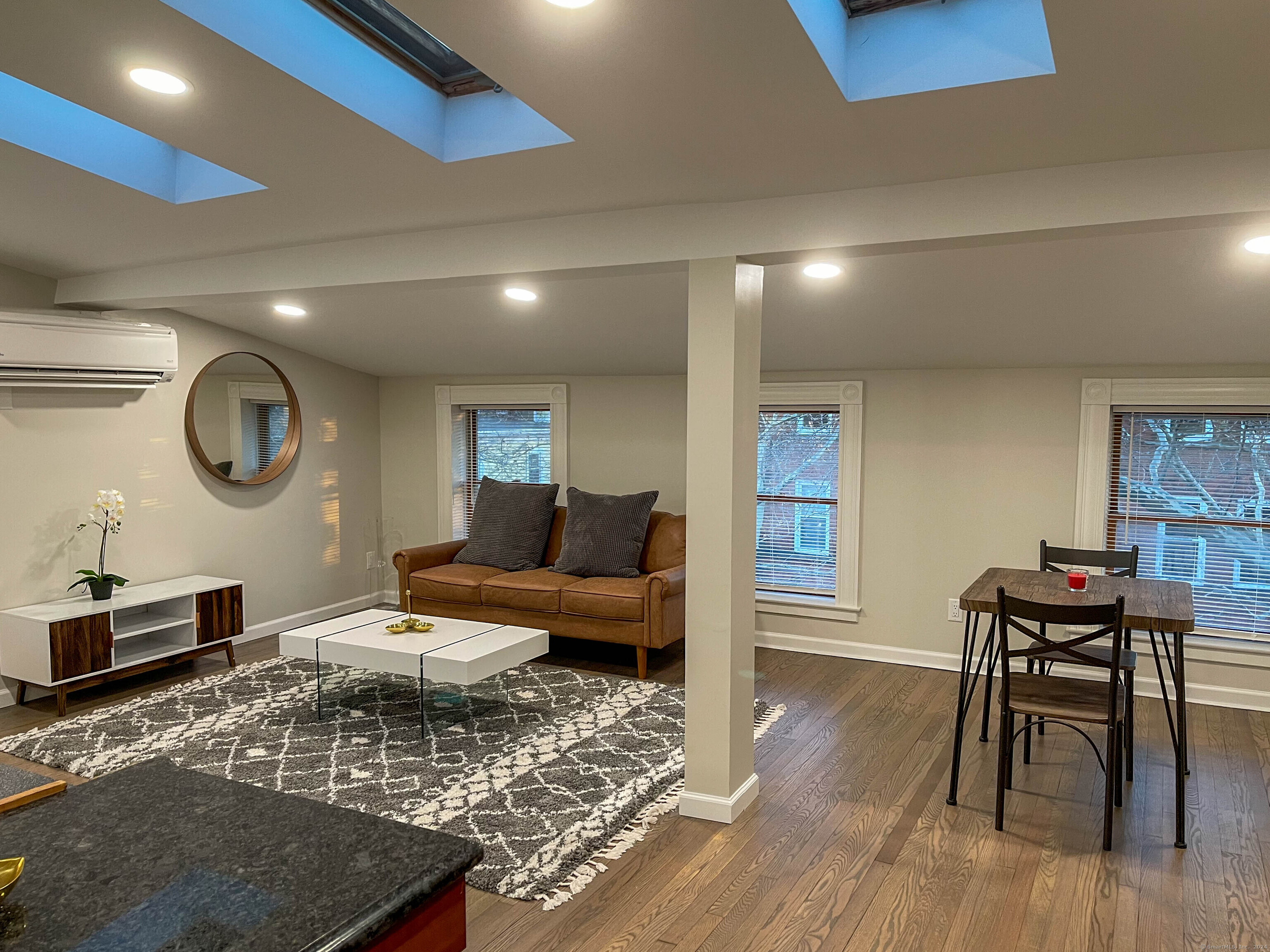 a living room with furniture and a wooden floor