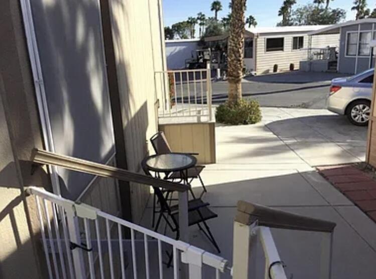 a view of a balcony with chairs and table