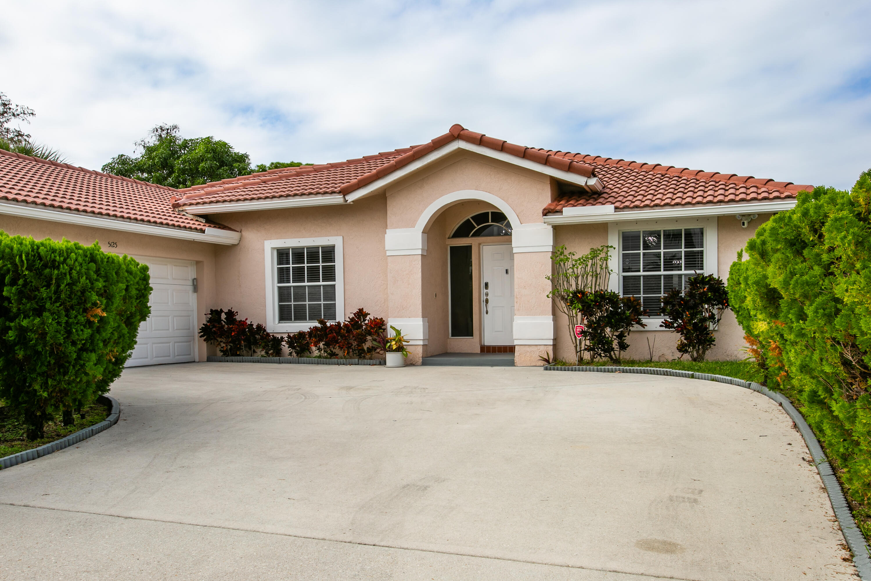 a view of a house with patio and a yard