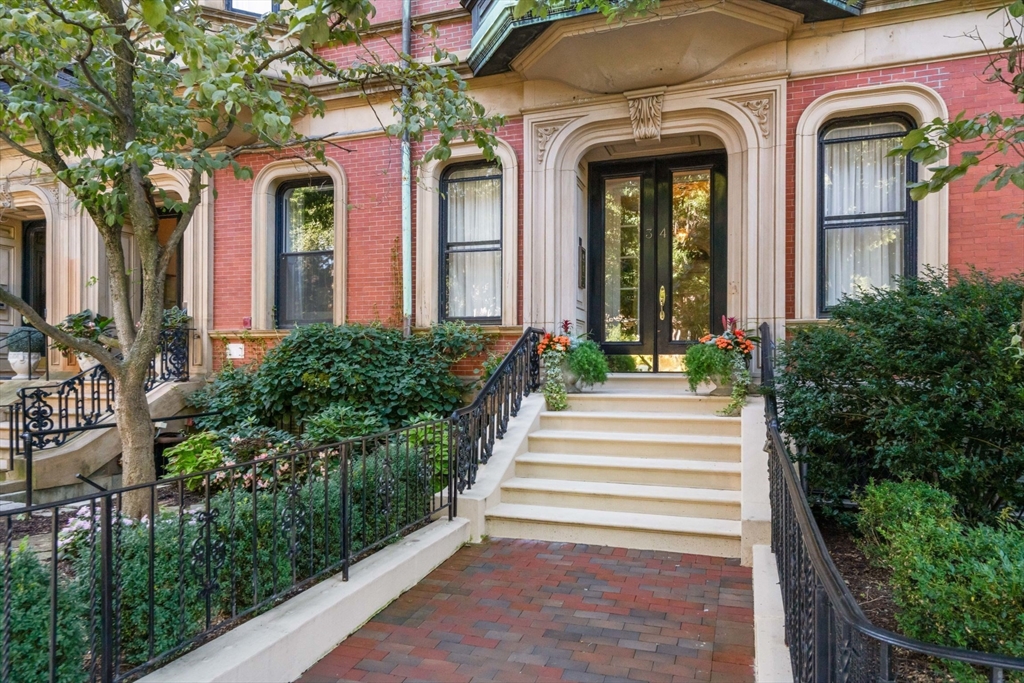 a view of a house with potted plants and more windows