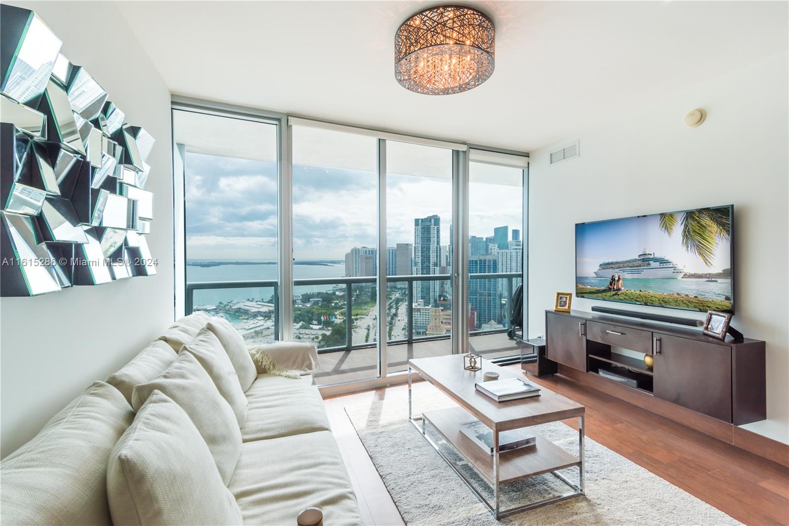 a living room with furniture and a floor to ceiling window