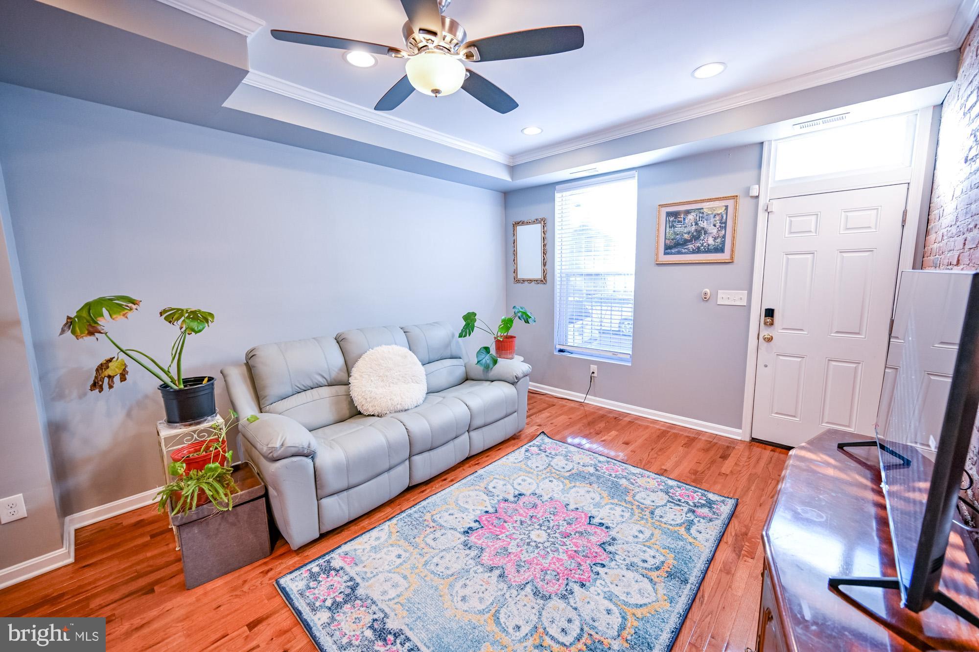 a living room with furniture and wooden floor