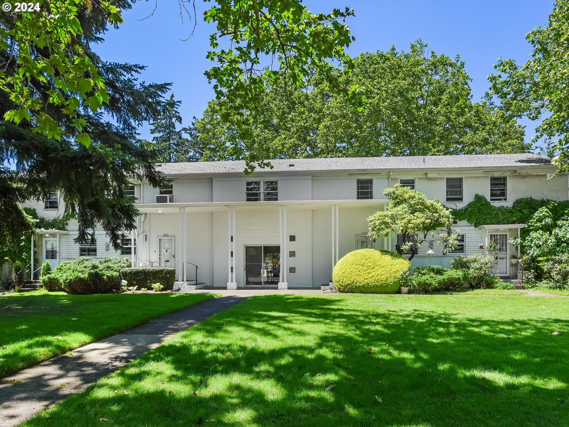 a front view of house with yard and green space