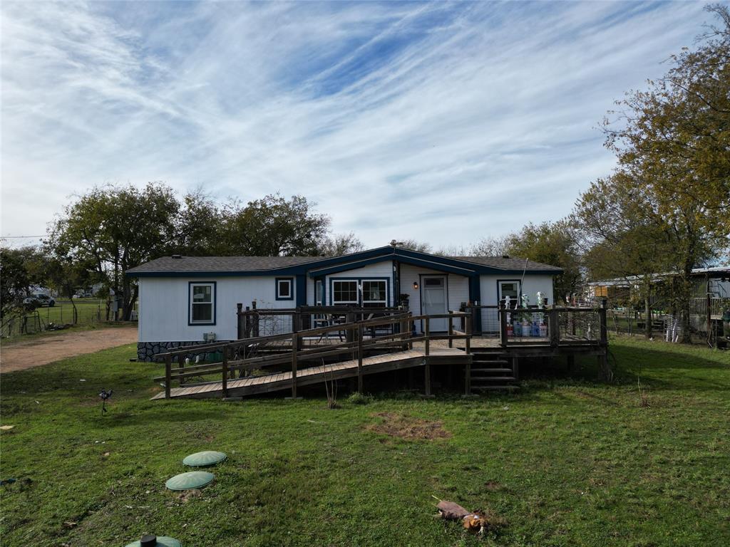 a view of a house with a backyard