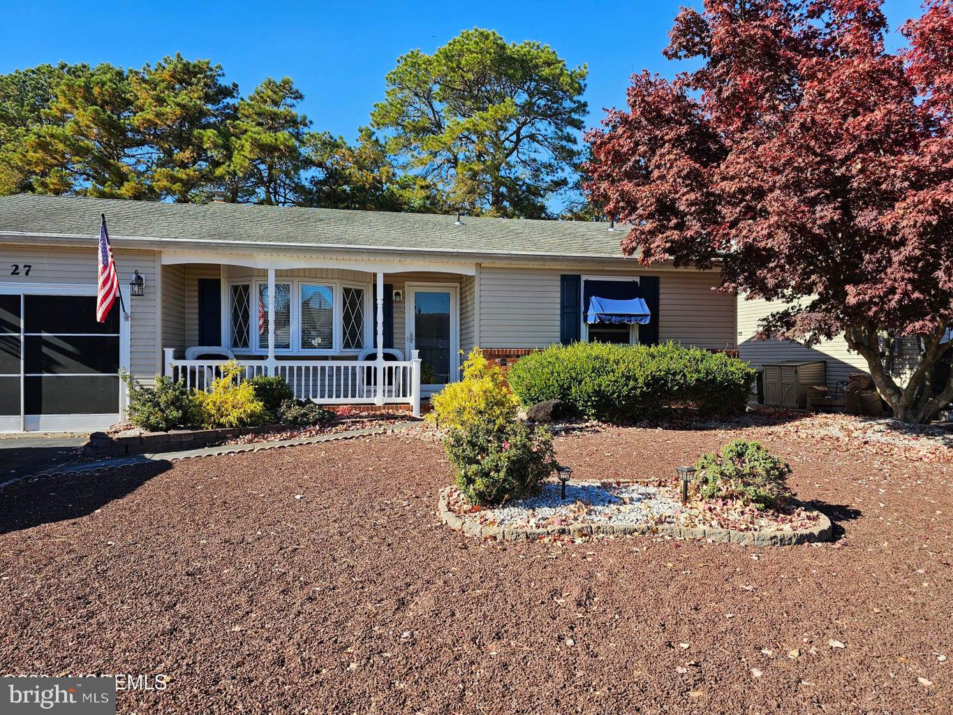 front view of house with a yard and potted plants