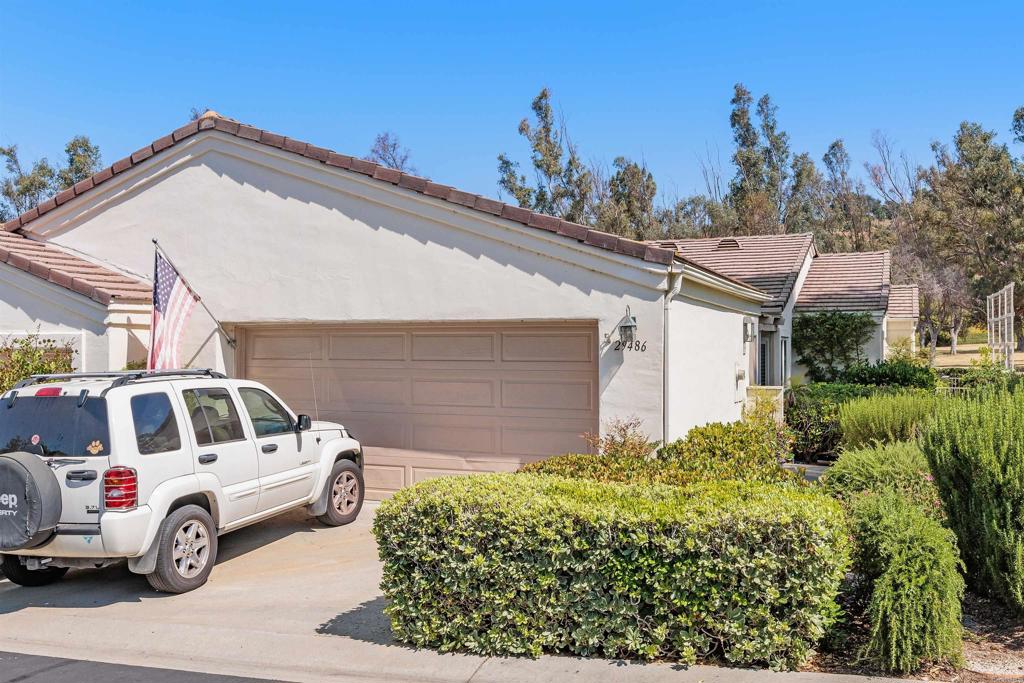 a view of a car park in front of a house