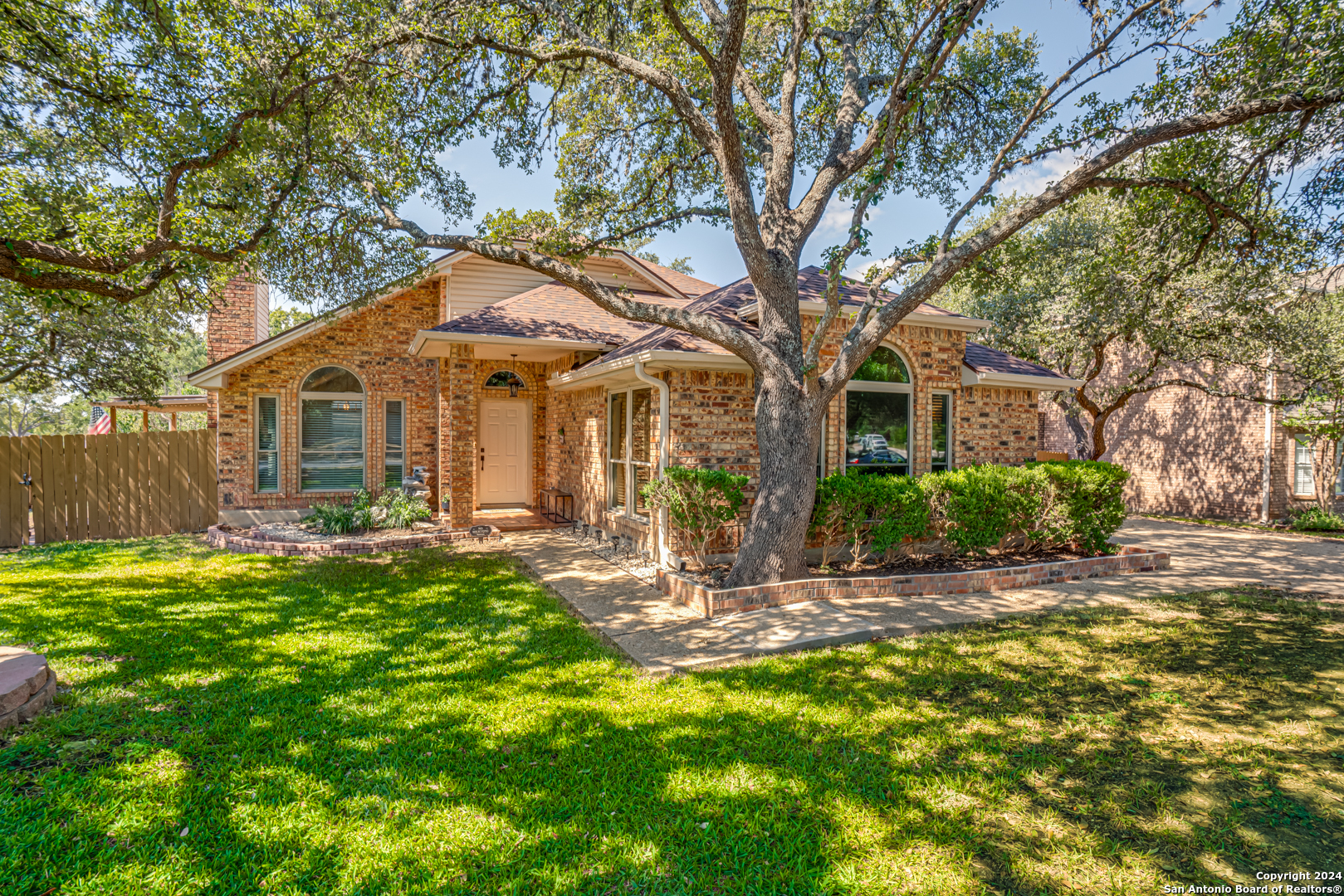 a front view of a house with yard patio and green space