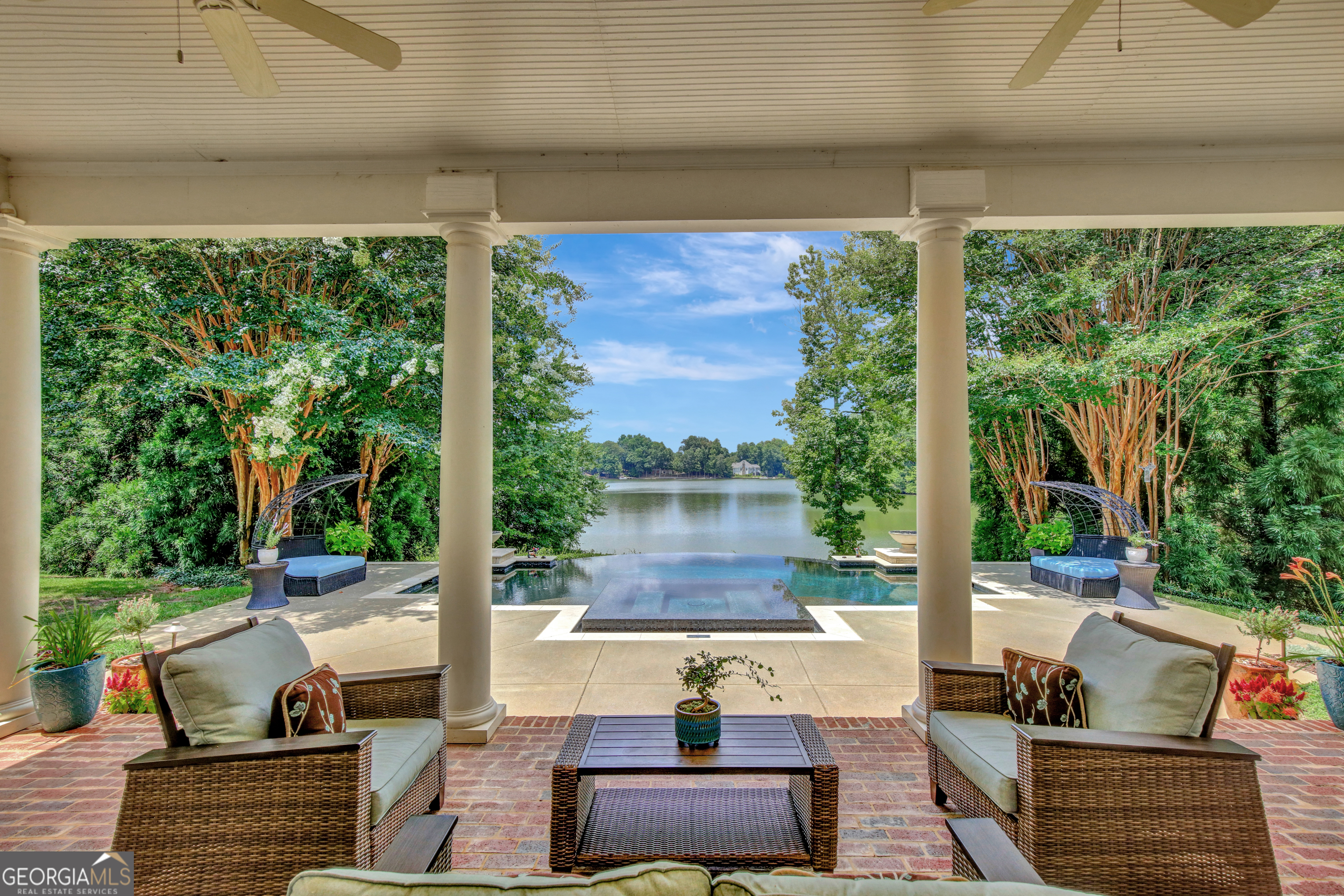 a view of a patio with table and chairs potted plants with large tree