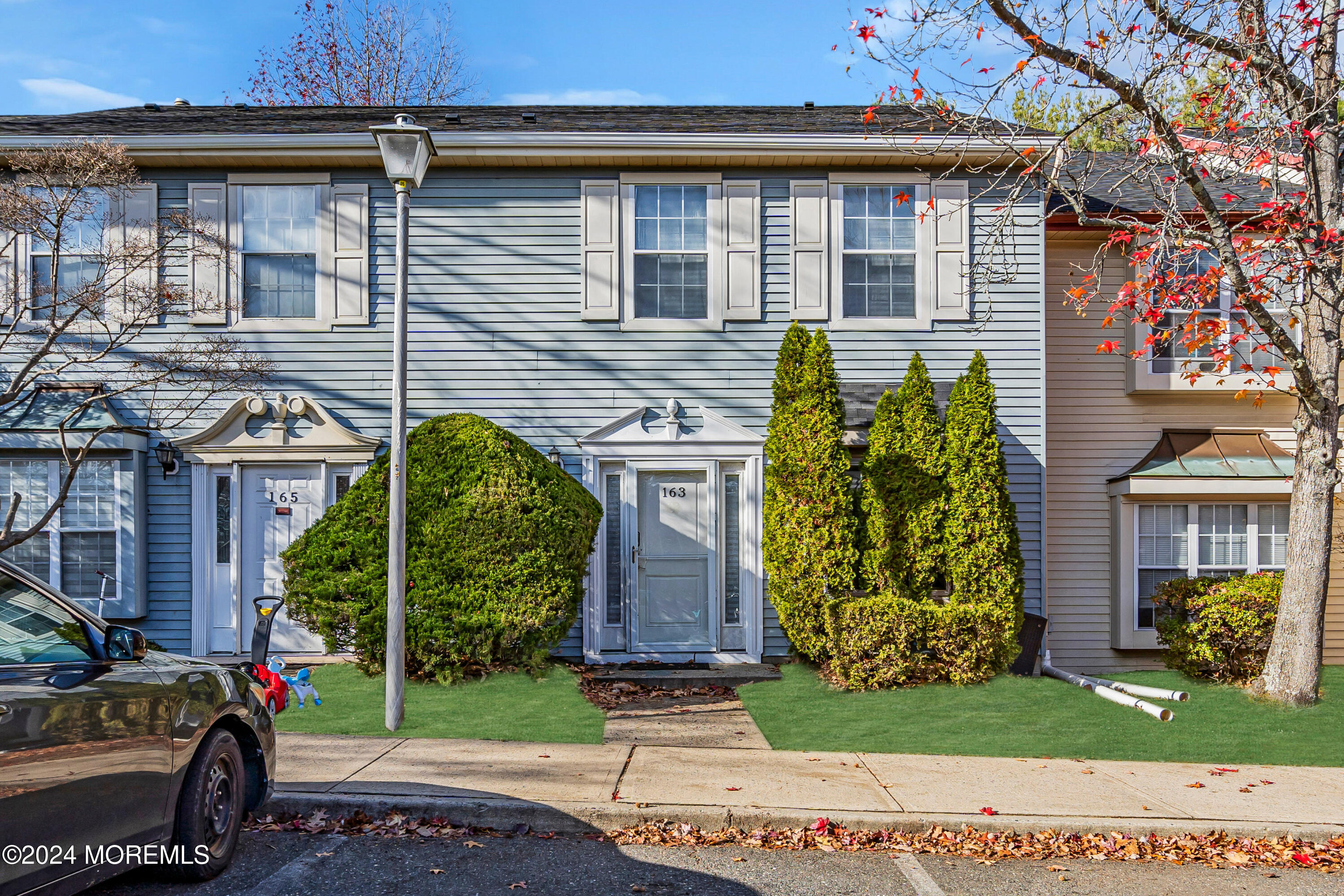 a view of a brick house with a yard