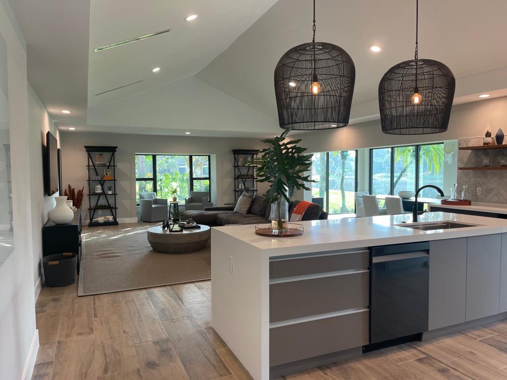 a kitchen with a sink and living room view