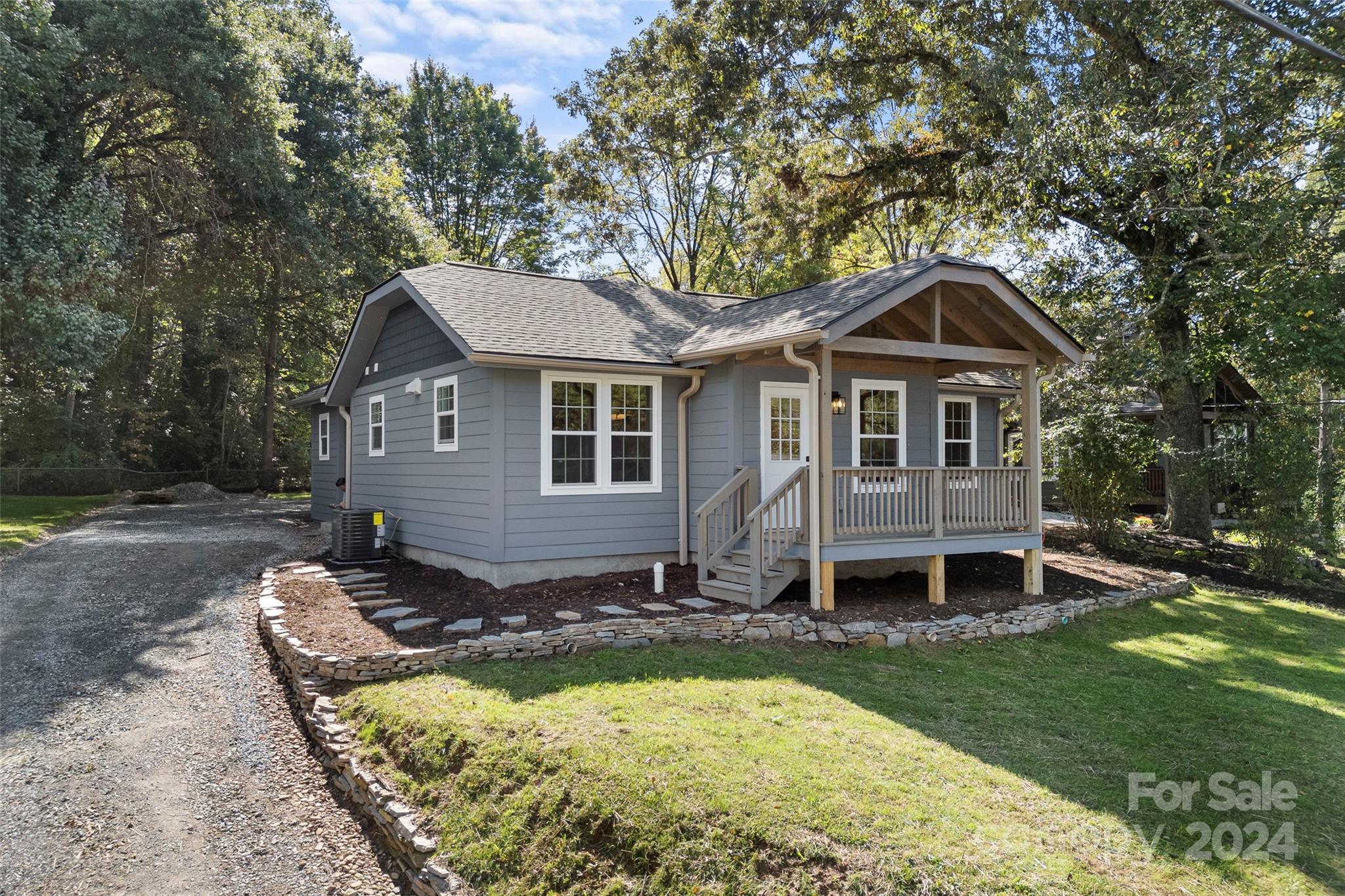 a front view of a house with a yard table and chairs