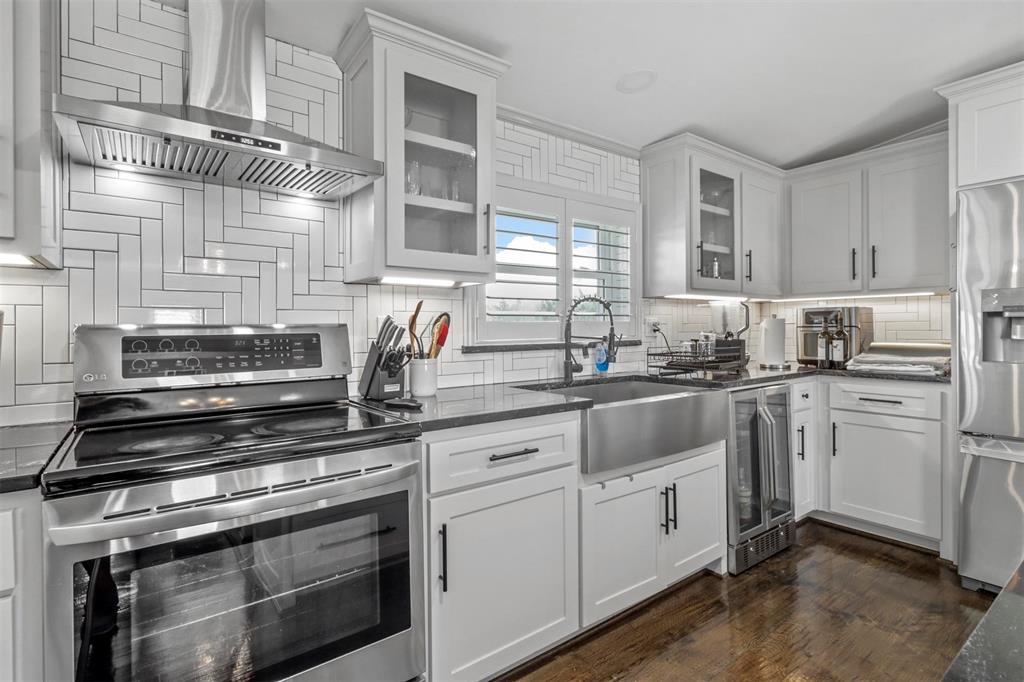 a kitchen with appliances cabinets and a sink