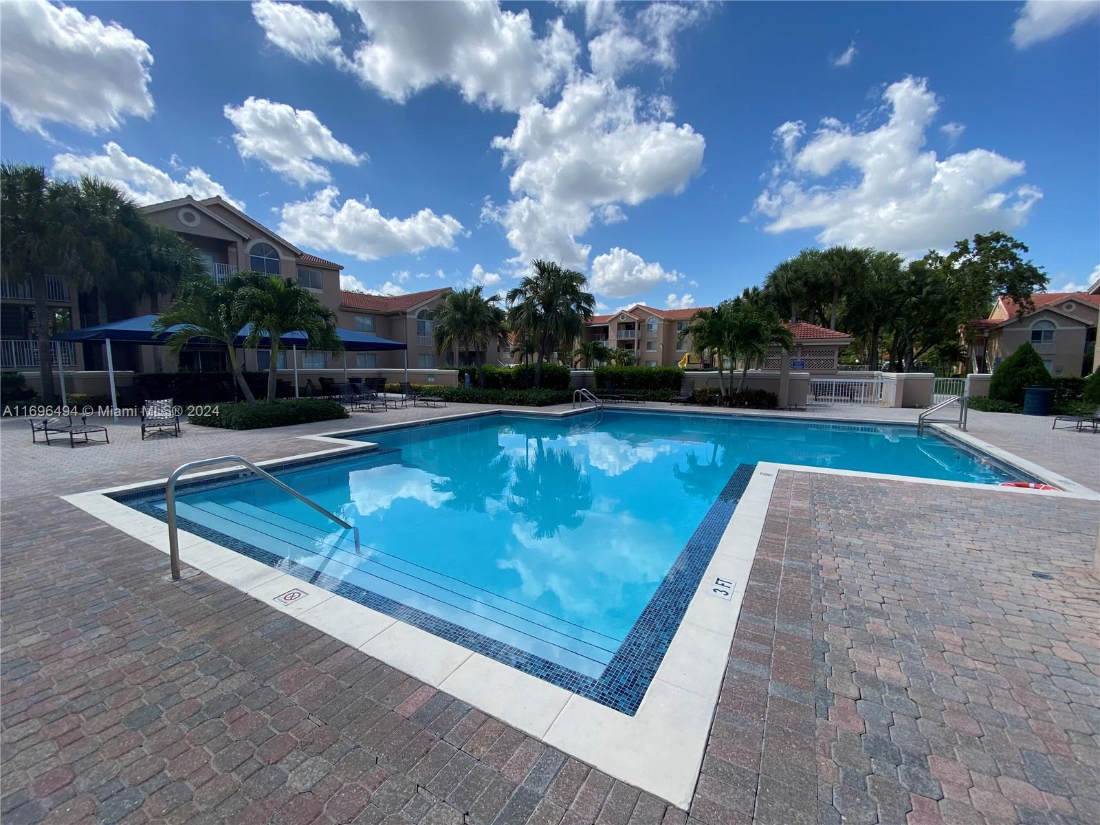 a view of a swimming pool with a patio