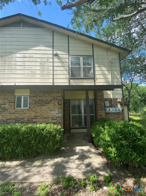 a view of a house with a yard and large window