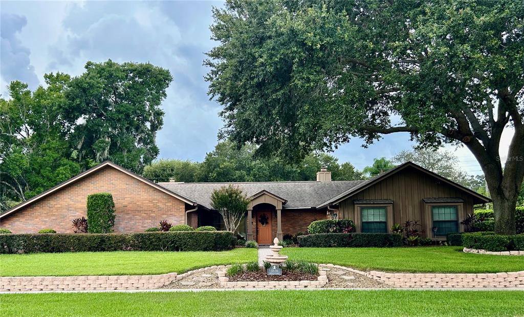 a front view of house with yard and green space