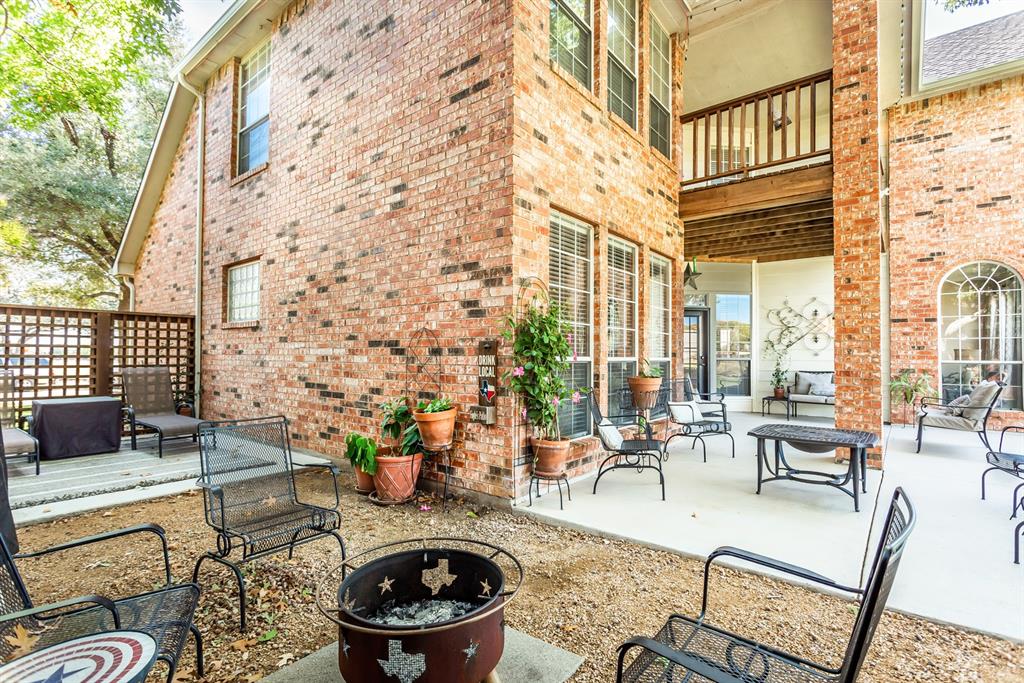 a view of a patio with couches table and chairs and potted plants