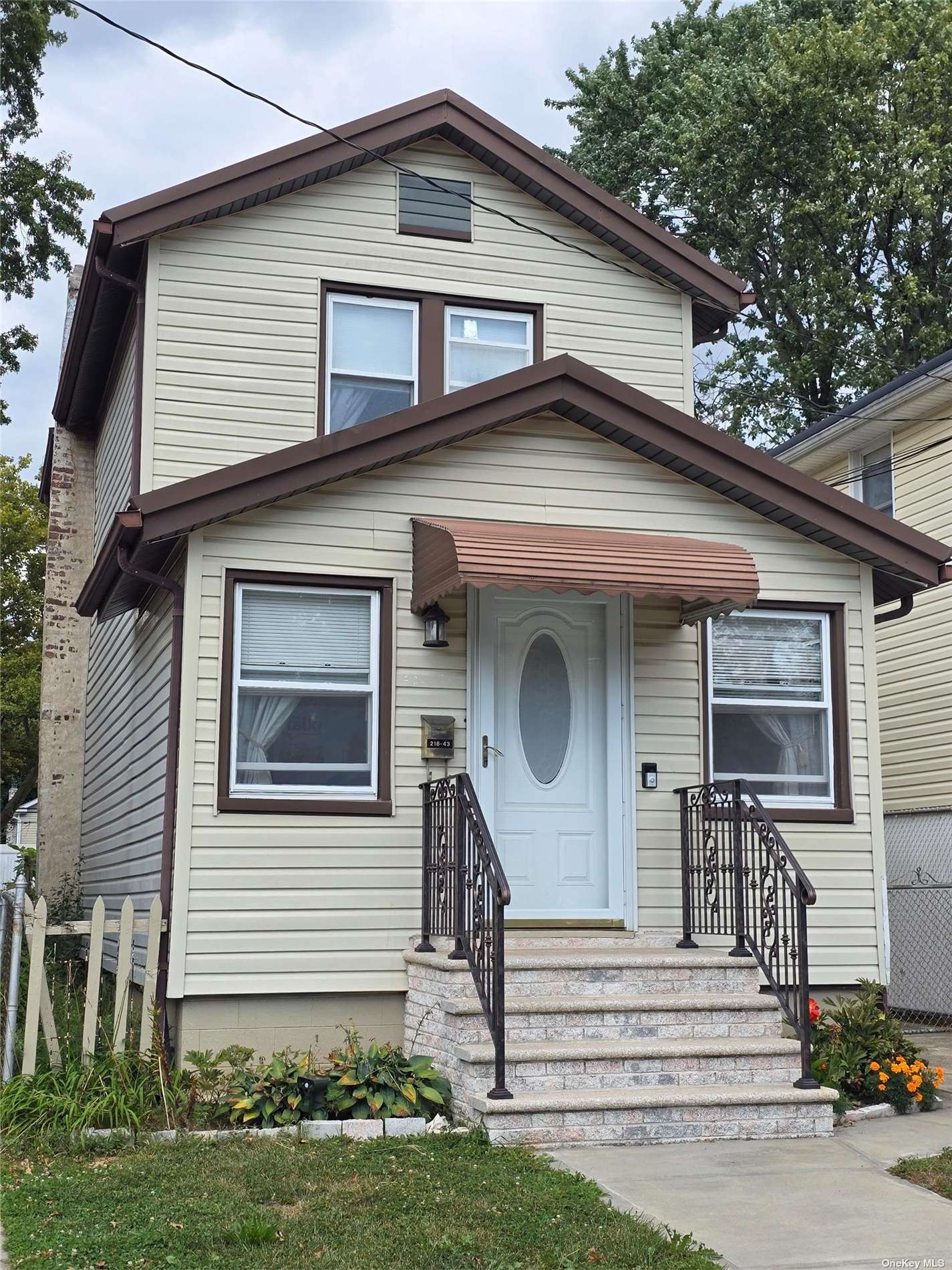 a front view of a house with a small yard