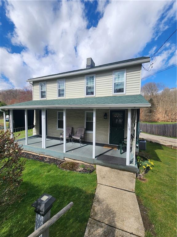 a front view of a house with a yard and porch