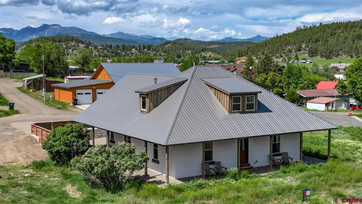 an aerial view of a house with yard and outdoor seating