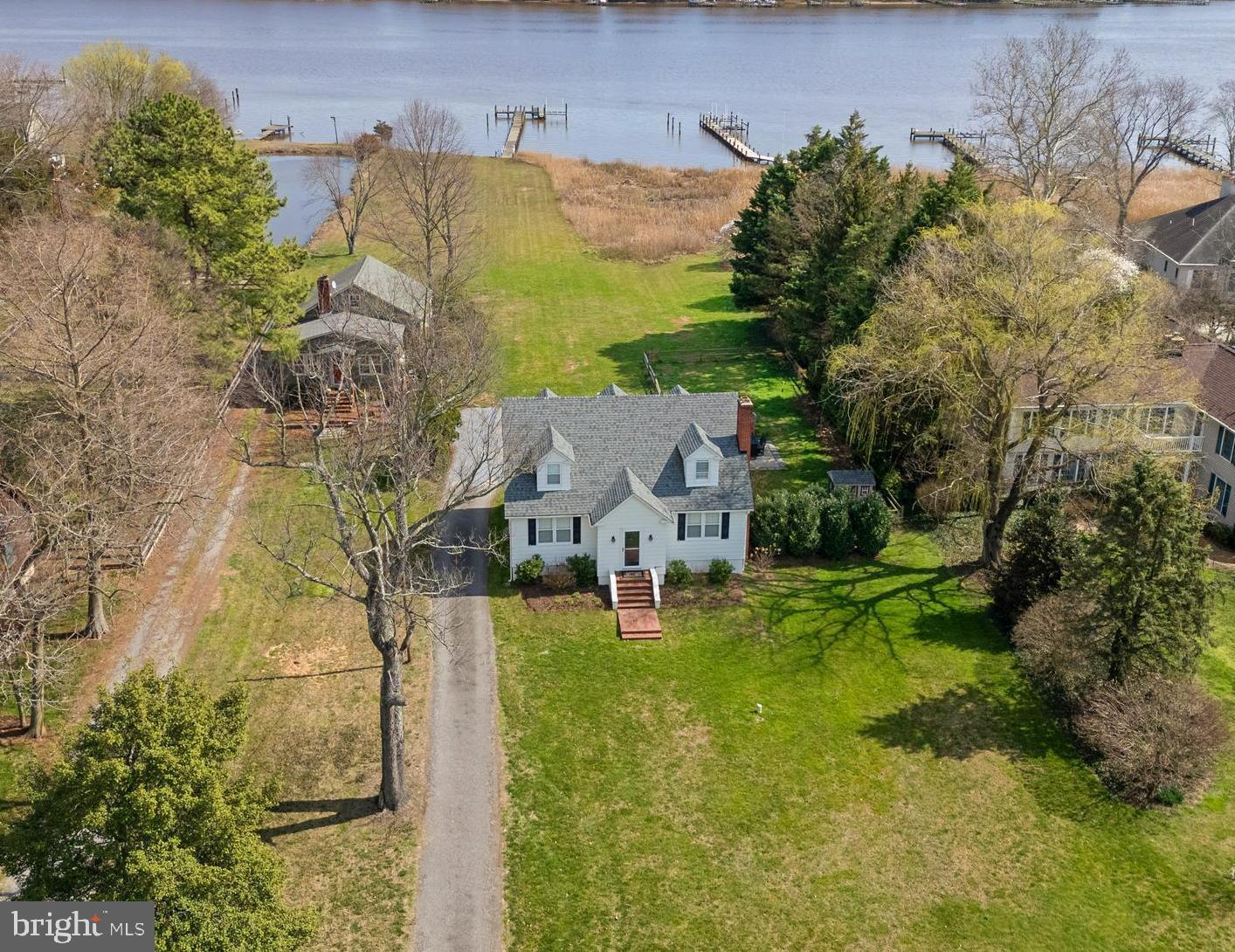 an aerial view of residential houses with outdoor space and trees