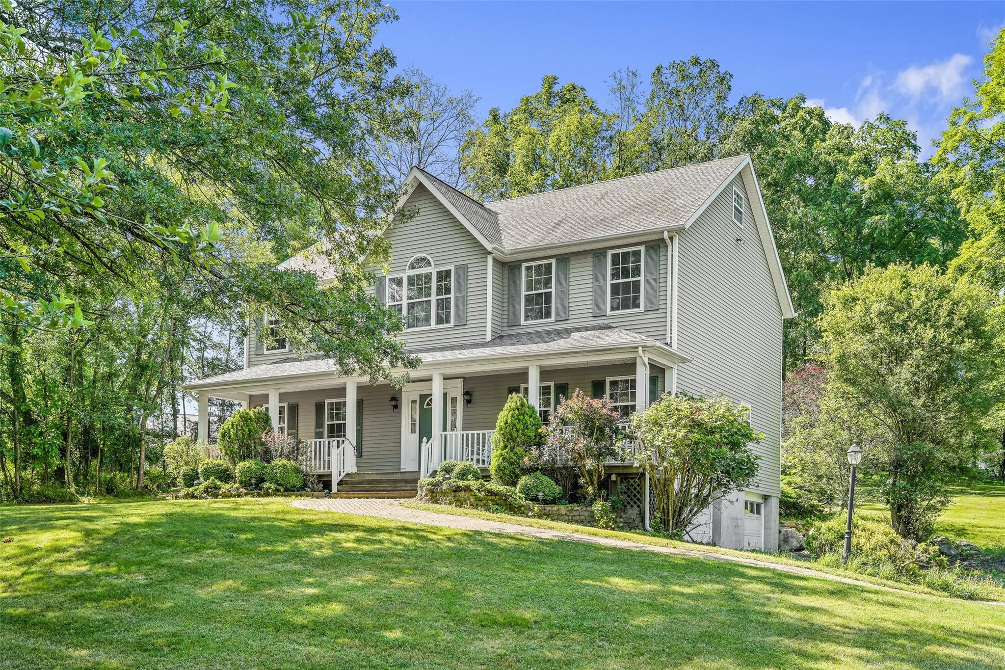 View of front of house with a front lawn and a porch