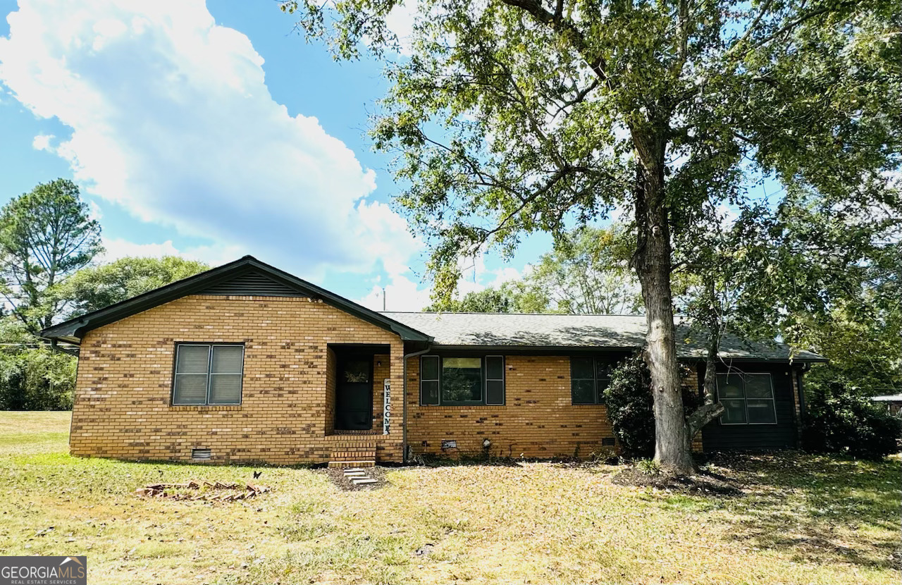 a front view of a house with a yard