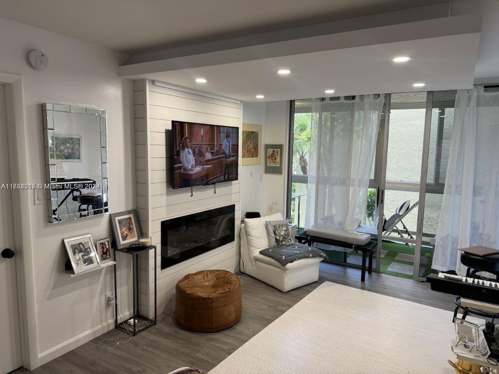 a living room with furniture flat screen tv and a fireplace