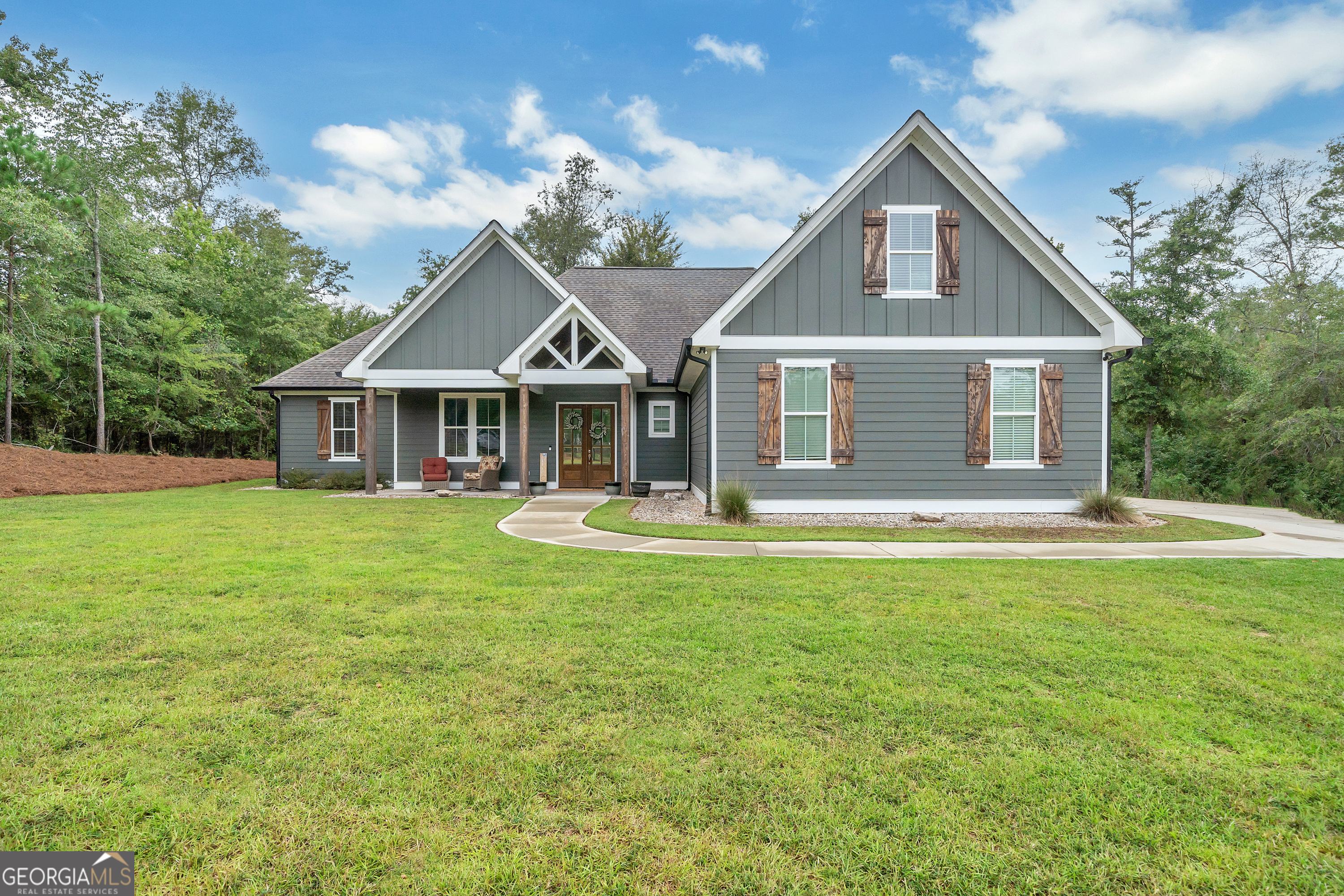 a front view of house with yard and green space