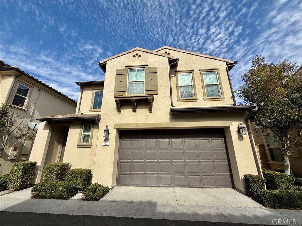 a front view of a house with garage