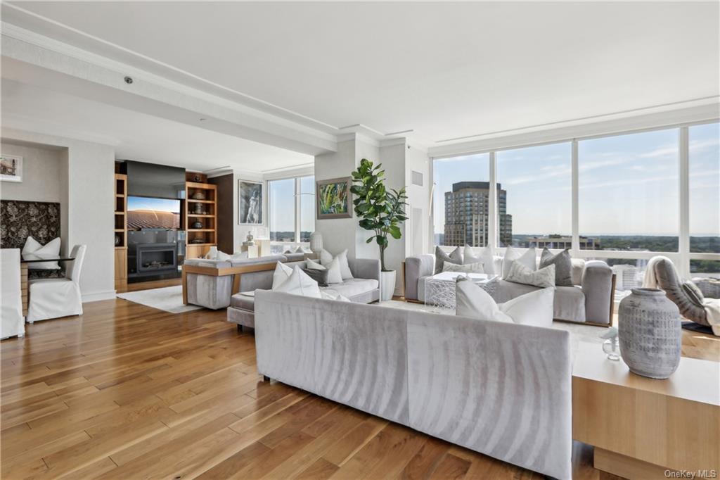 a living room with fireplace furniture and floor to ceiling window