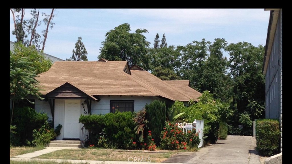 a aerial view of a house with a yard and potted plants