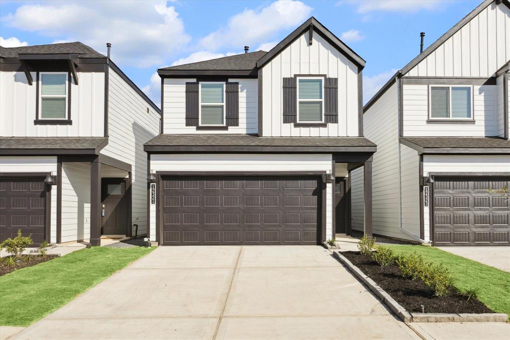 a front view of a house with a yard and garage