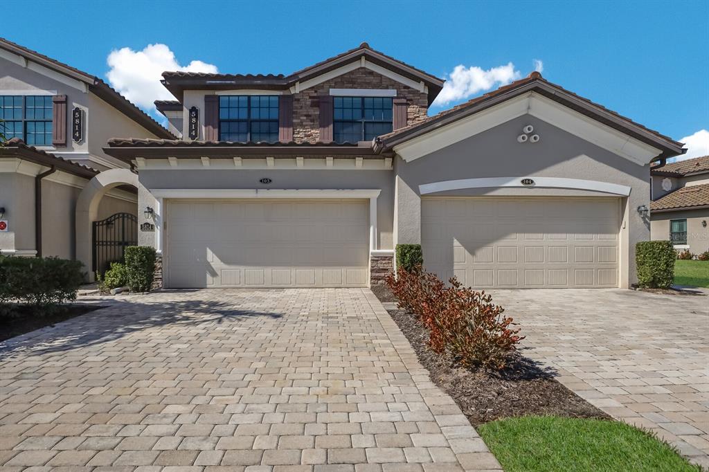 a front view of a house with a yard and garage