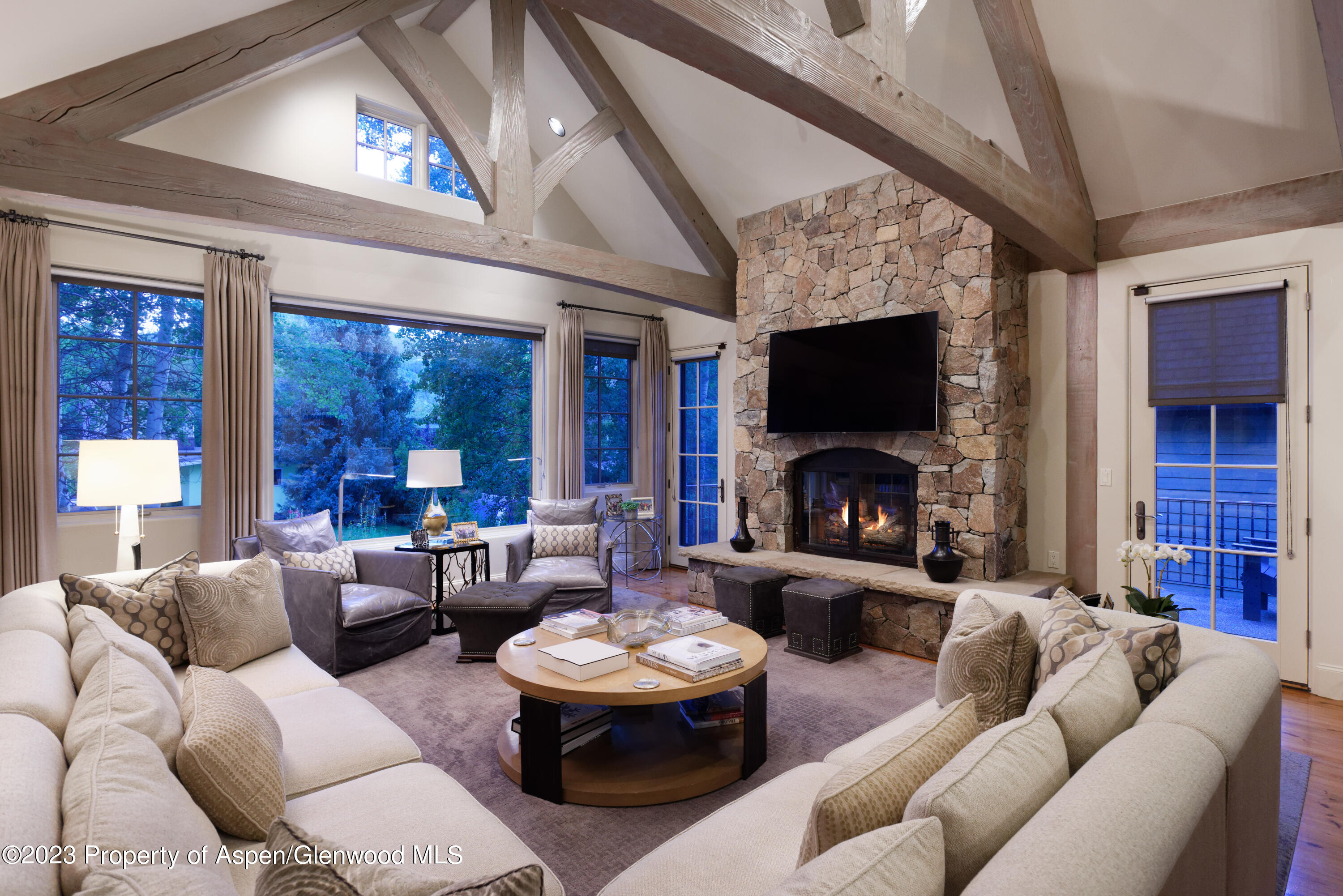 a living room with furniture a fireplace and a flat screen tv