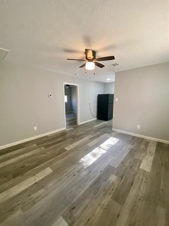 a view of a room with a ceiling fan and window