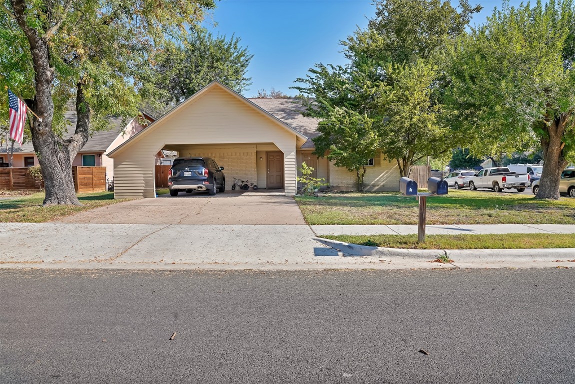 Nice corner lot with big trees. 1 carport space for each side, but 2 car off street tandem parking. Sidewalk on 2 sides.  1/2 block from Odom Elementary School.