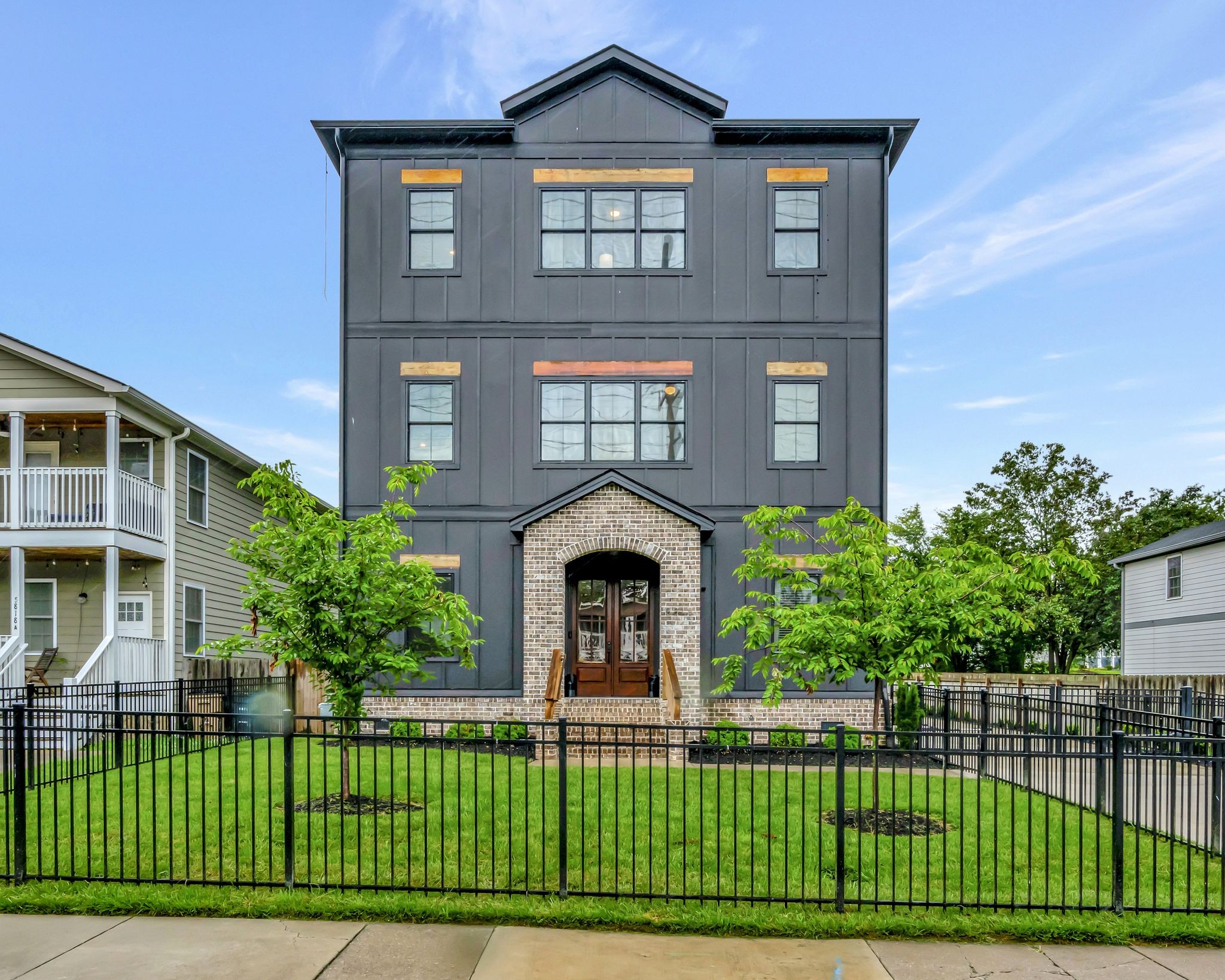 a front view of a house with a garden