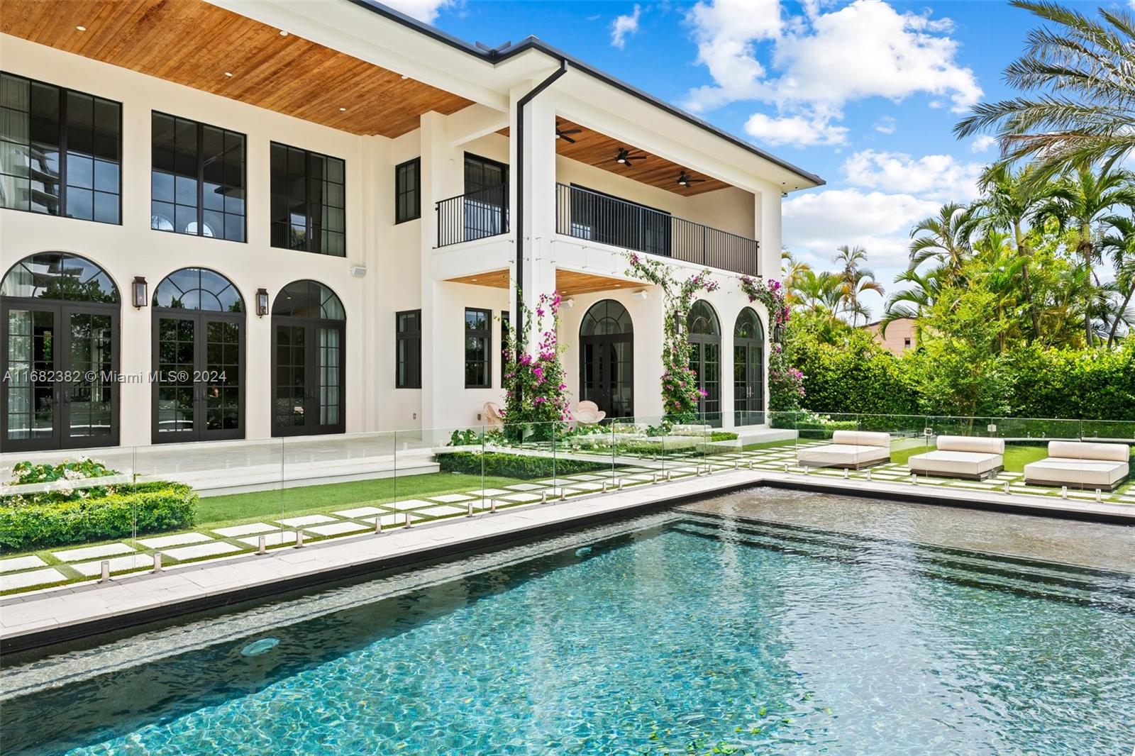 a front view of a house with swimming pool and a yard