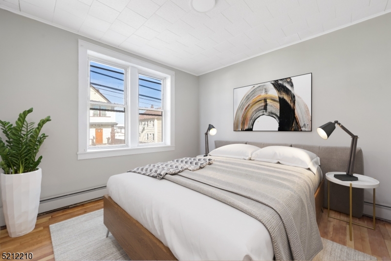 a bedroom with a large bed and a potted plant