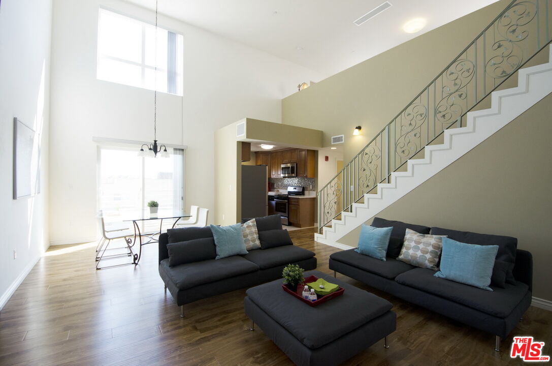 a living room with furniture and wooden floor