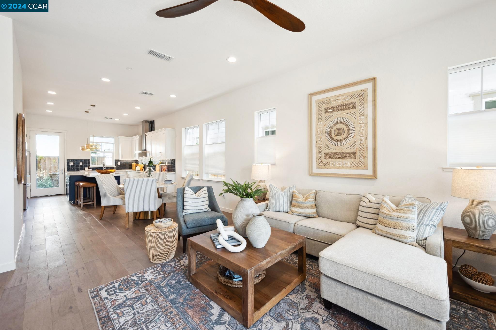 a living room with furniture kitchen view and a table