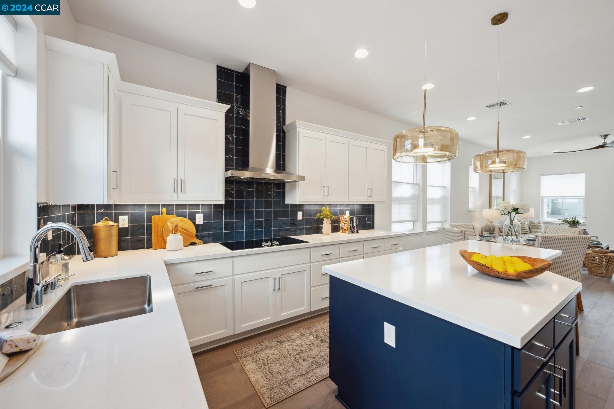 a kitchen with a sink a counter space appliances and cabinets